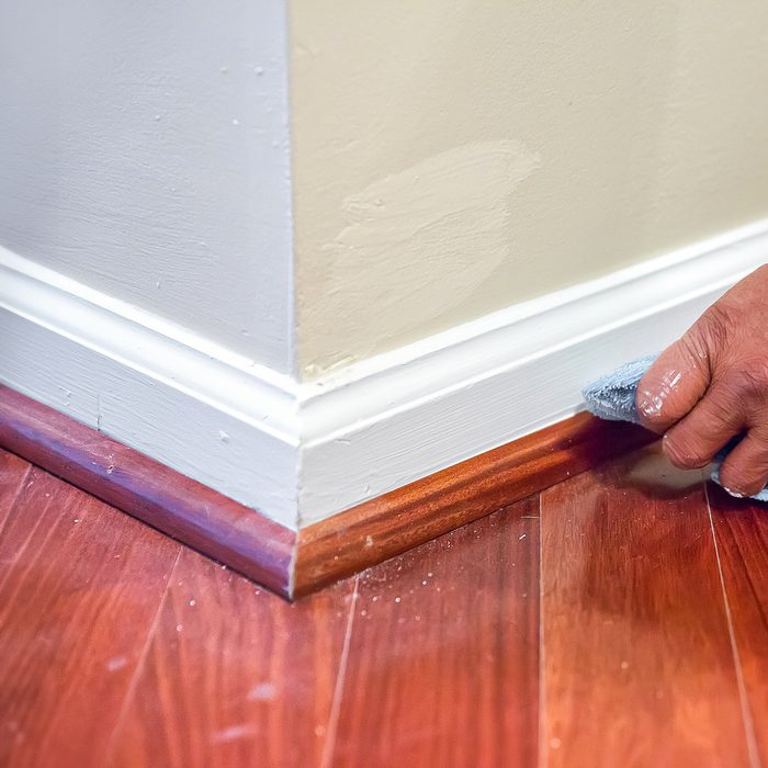 A Person Installing Shoe Molding