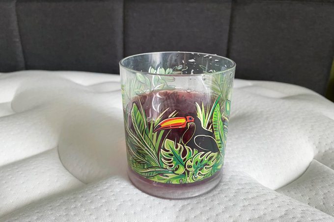 Cranberry juice on one side of the bed