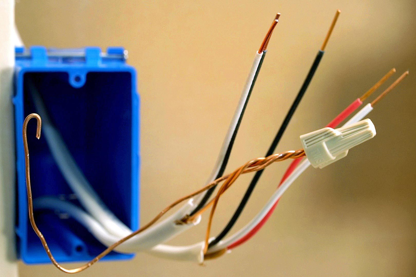 prepped wires for 3 way switch, one with a cap on it and the others stripped of the insulation