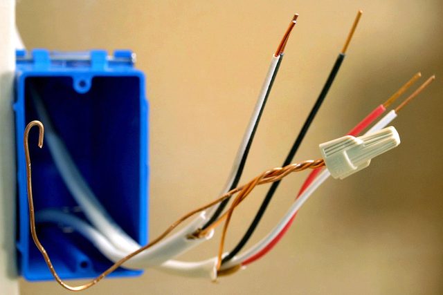 prepped wires for 3 way switch, one with a cap on it and the others stripped of the insulation