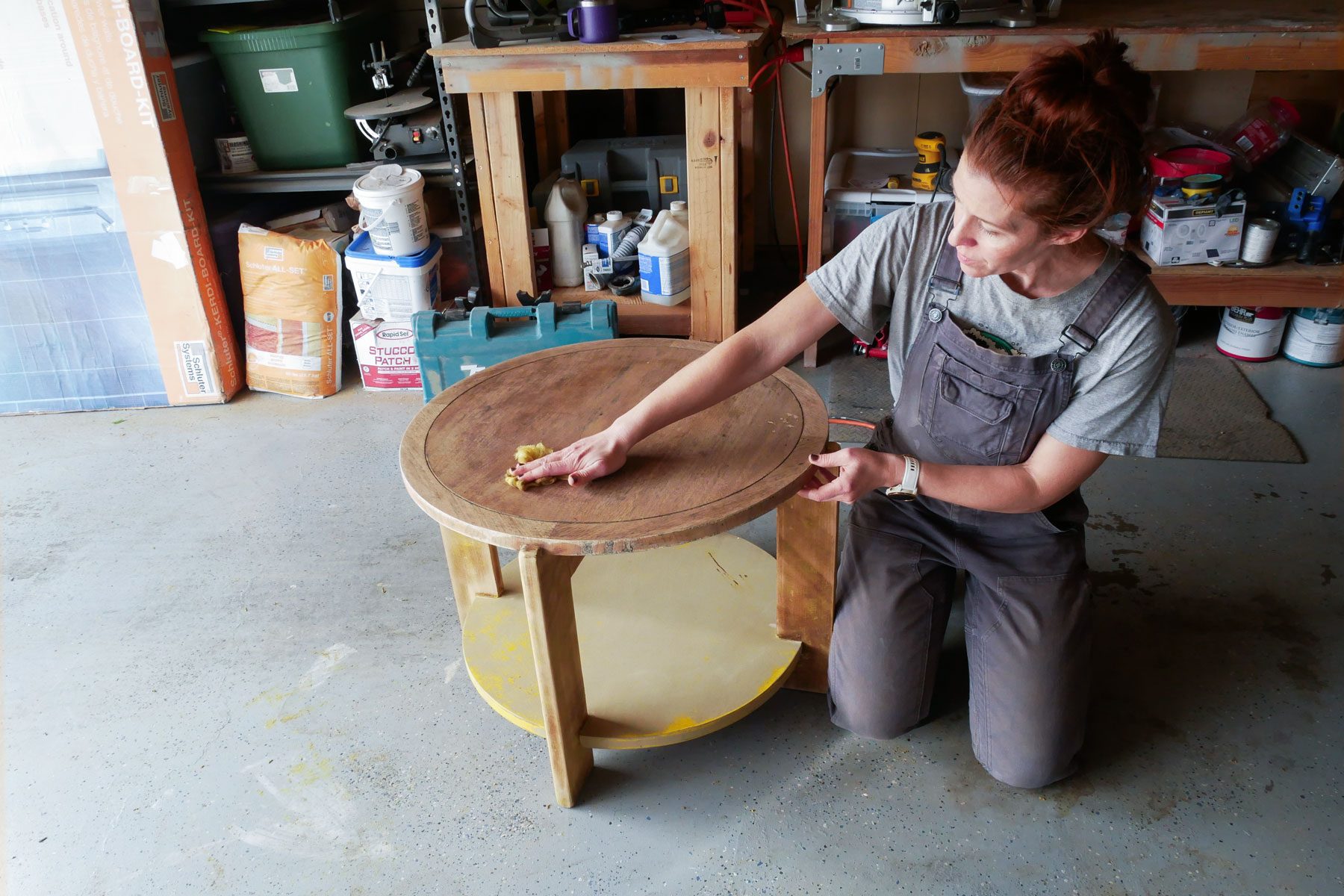 A person using a cloth to polish the surface of table