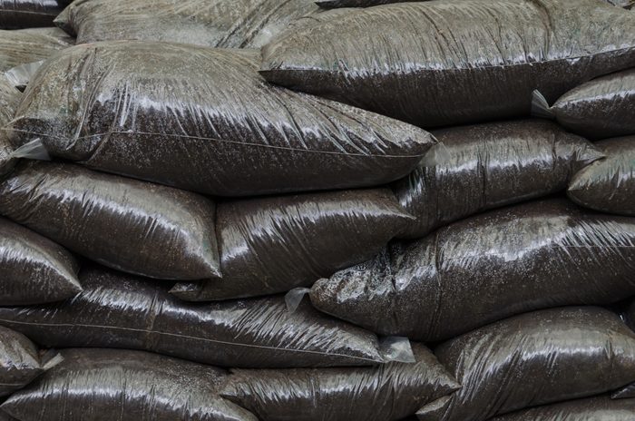 A stack of bags of Top Soil in a garden centre