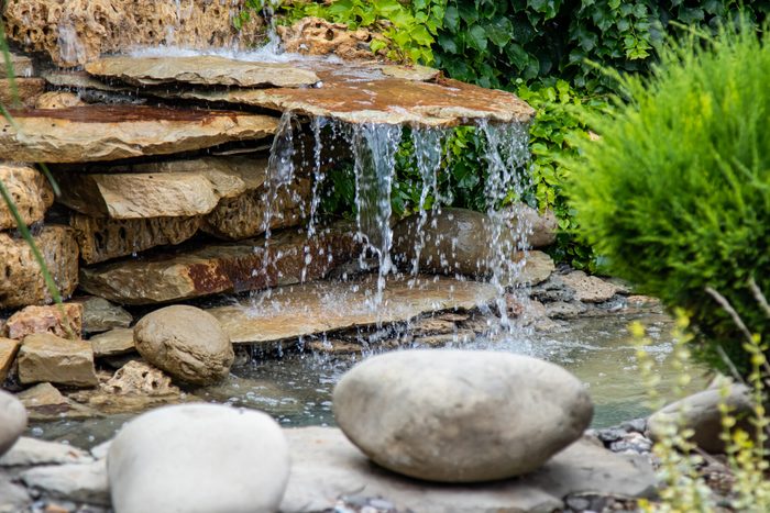 A small decorative waterfall in the Park or in the garden. Landscape design