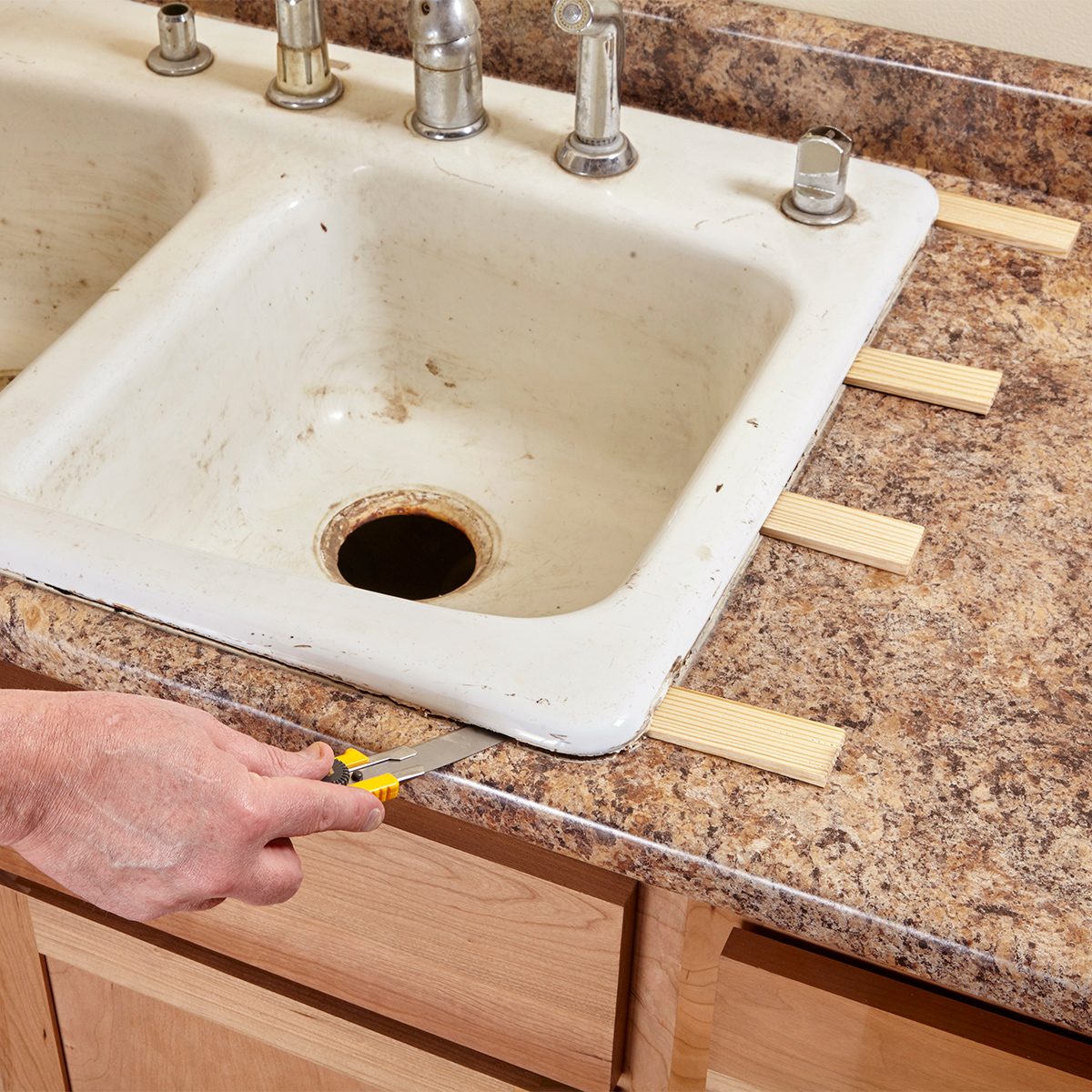 Putting wooden wedges under sink