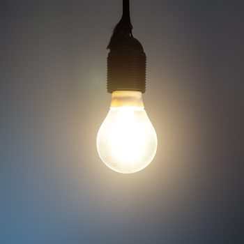 Lit Incandescent light bulb with a medium-sized E27.