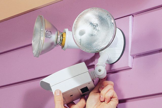 Hands can be seen adjusting motion sensors.