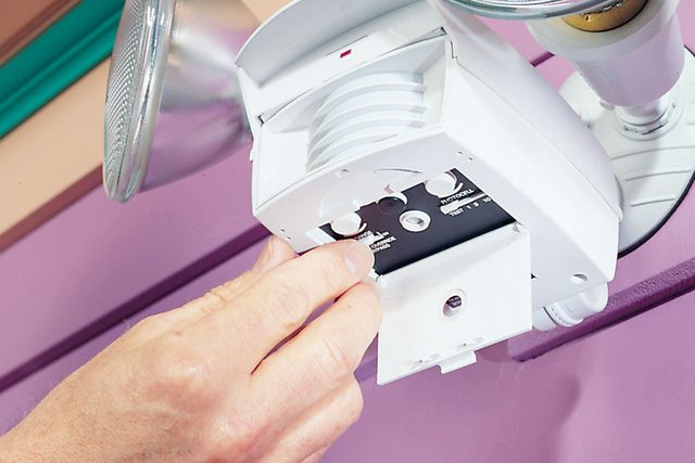 A hand can be seen adjusting sensor controls.