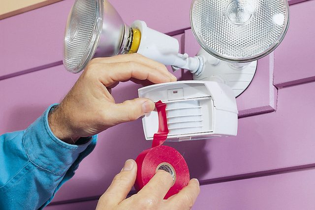 Hands can be seen using tape to adjust field of view of the sensor.