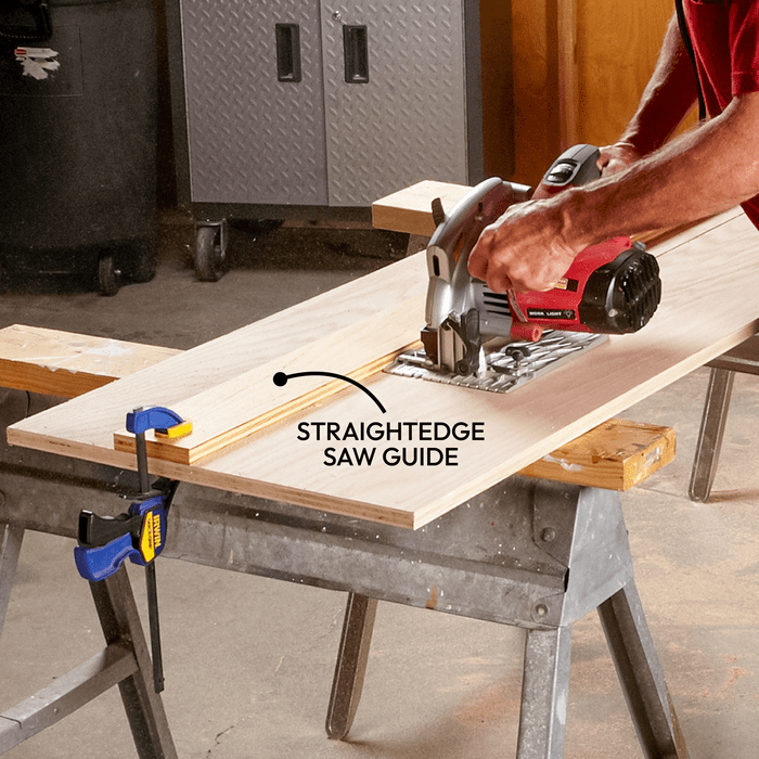 Man using a saw on wooden slab