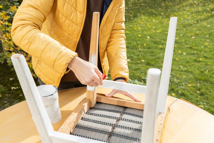 restoration of old furniture, painting with brush