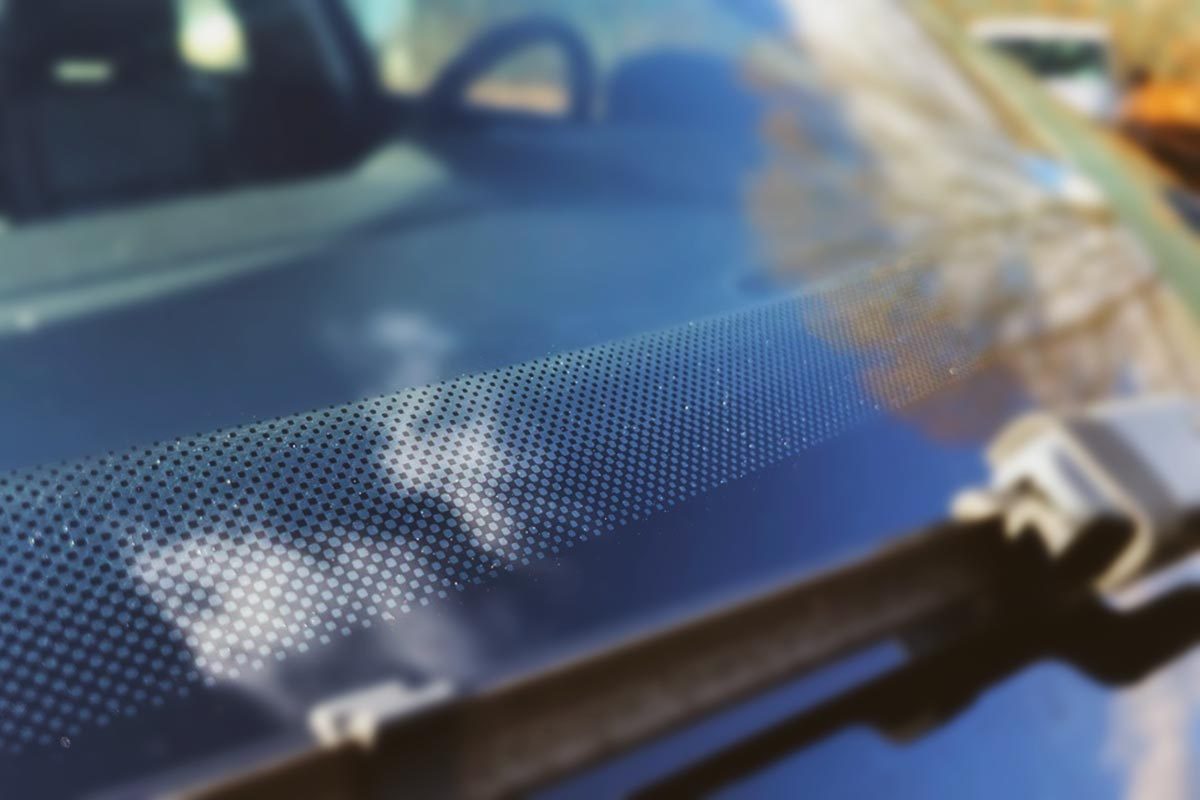 Here’s What Those Black Dots On Your Windshield Are For