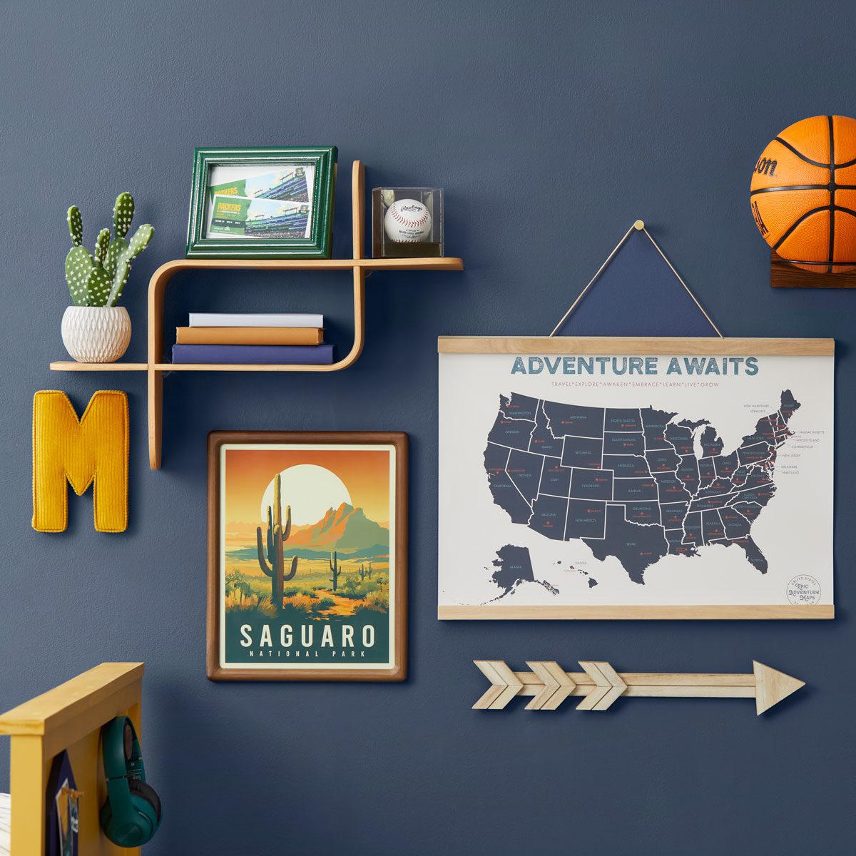 Stunning Gallery Wall with a variety of art and objects on a navy blue wall