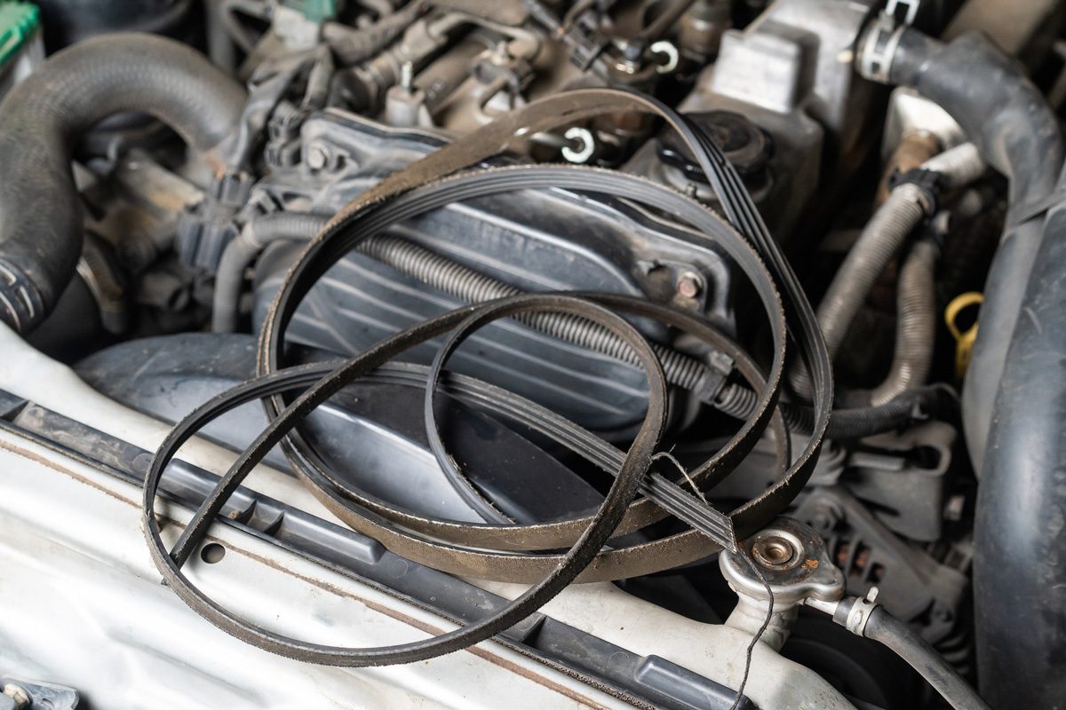expired automotive belt on car engine