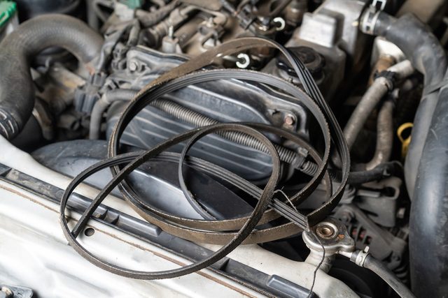 expired automotive belt on car engine