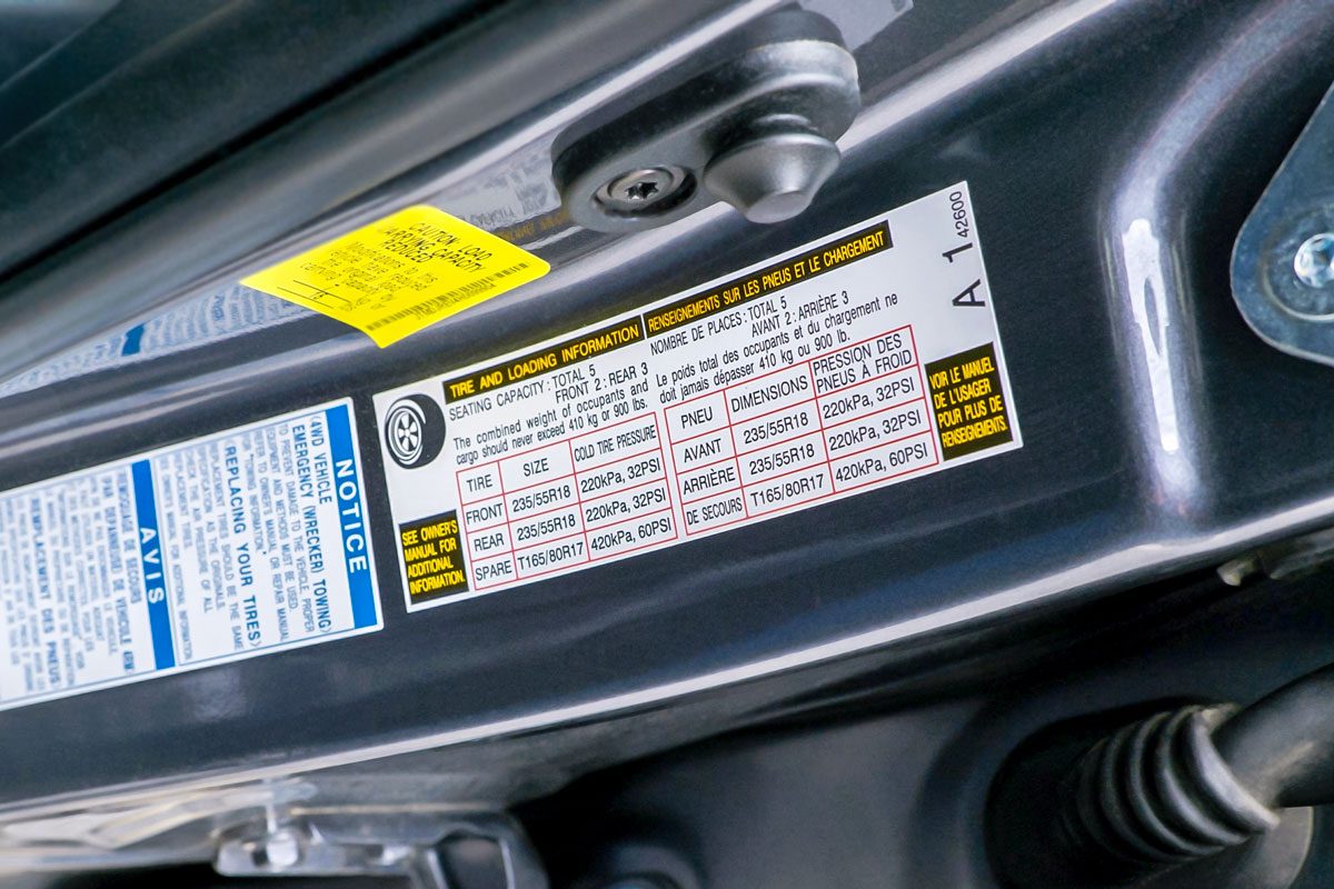 stickers on a car door that contains information about the car, such as tire size, load capacity, and towing instructions;