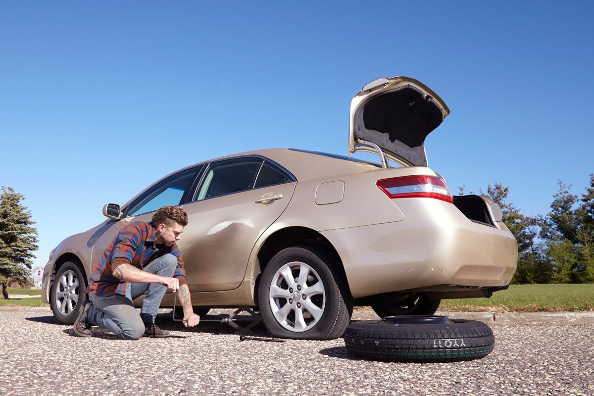 man changing car tires