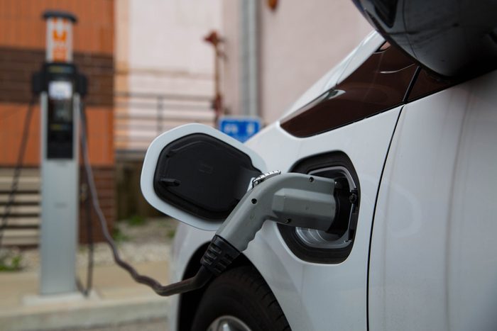 electric car charging at charging station