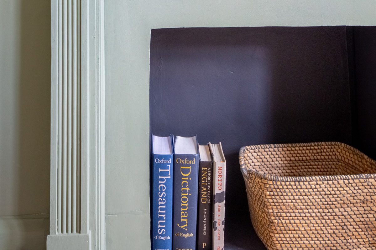 a basket and some books inside a fireplace