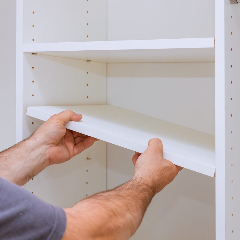 man putting in shelves