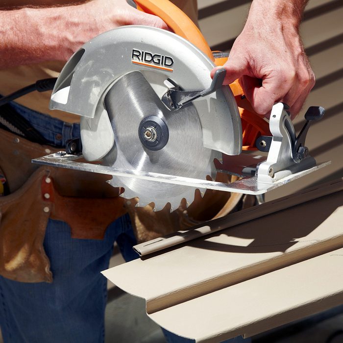 A man using a circular saw.