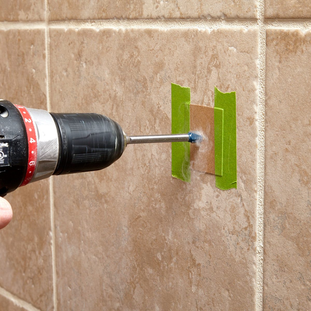 A hand holding a screwdriver.