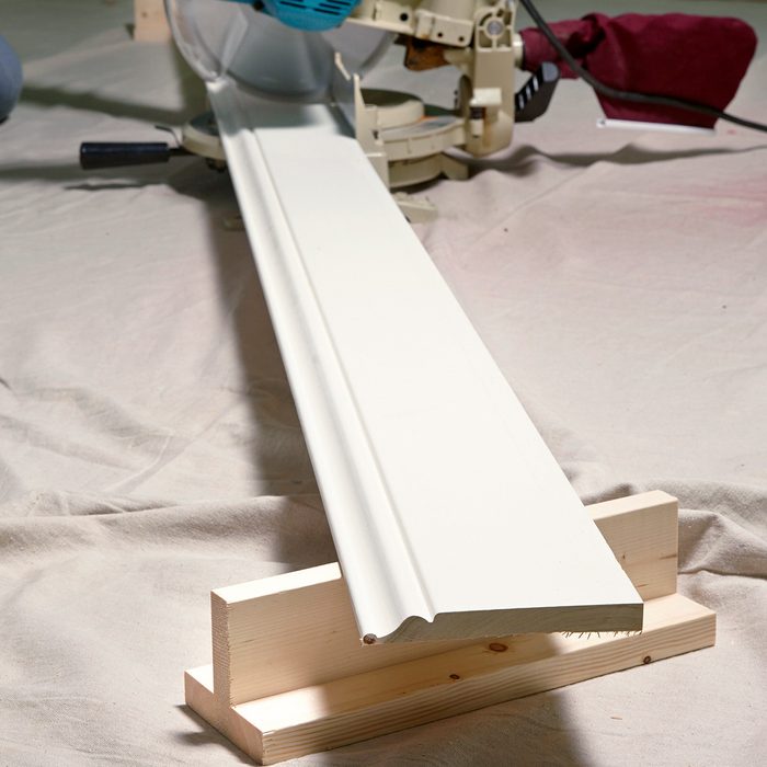 A woodworking machine cutting a white board.
