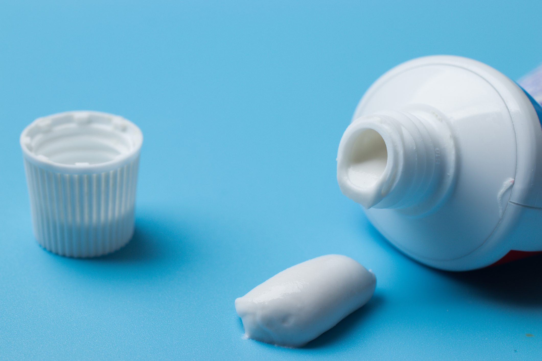 Toothpaste close-up on blue background