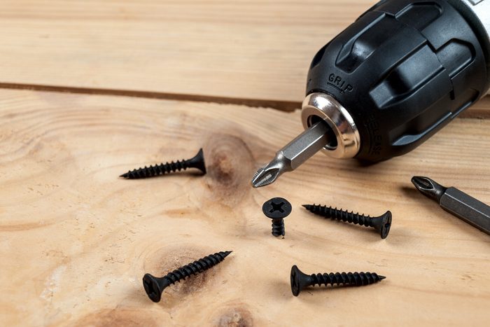 screws self-tapping screws on the background of a screwdriver, a selection of different self-tapping screws for different materials of walls and surfaces