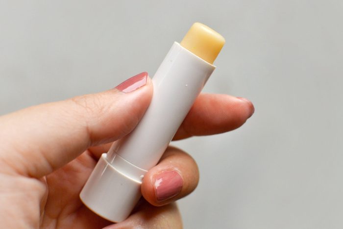 Woman holding a lip balm