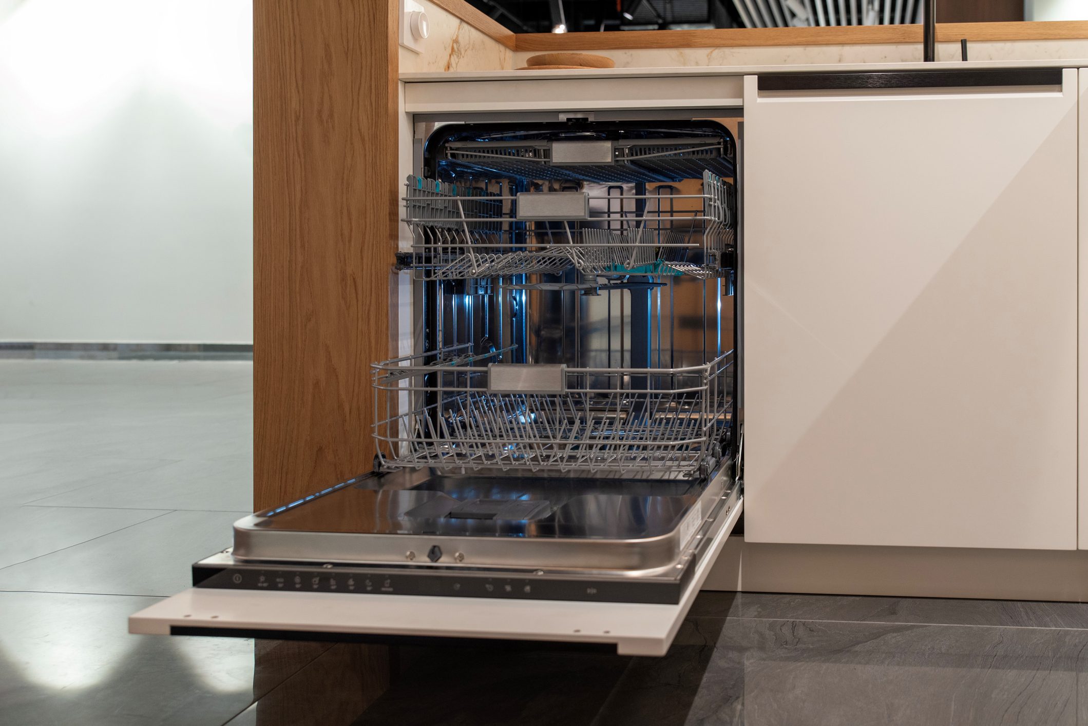 Empty, open built-in dishwasher