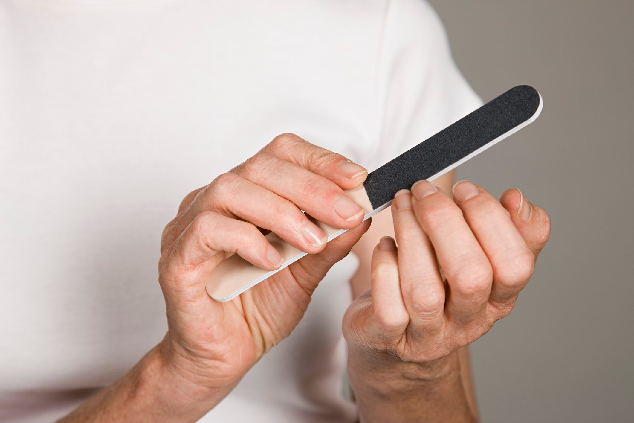 Woman filing her nails