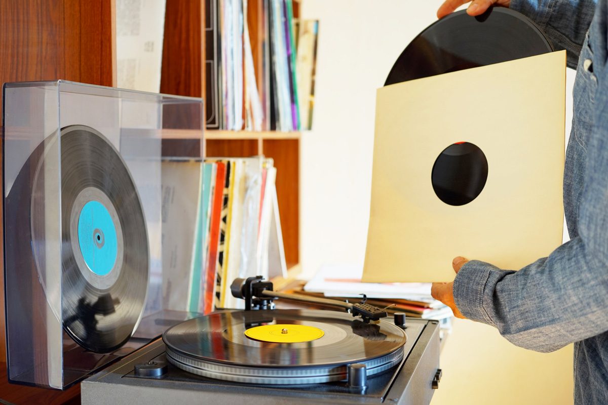 man selecting record to play