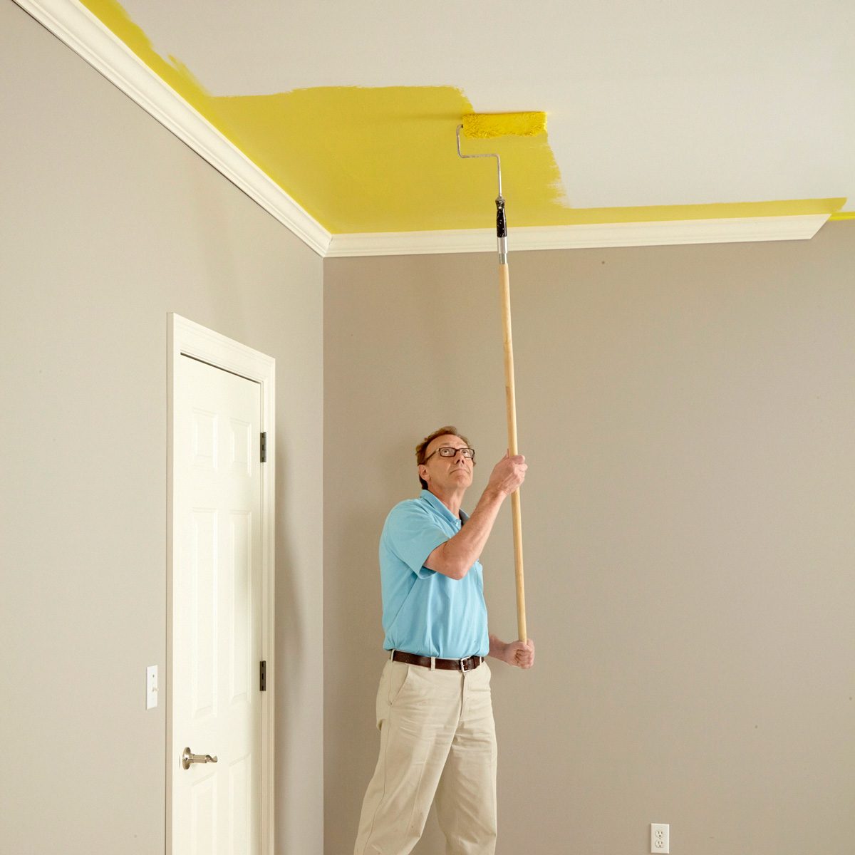 man painting ceiling