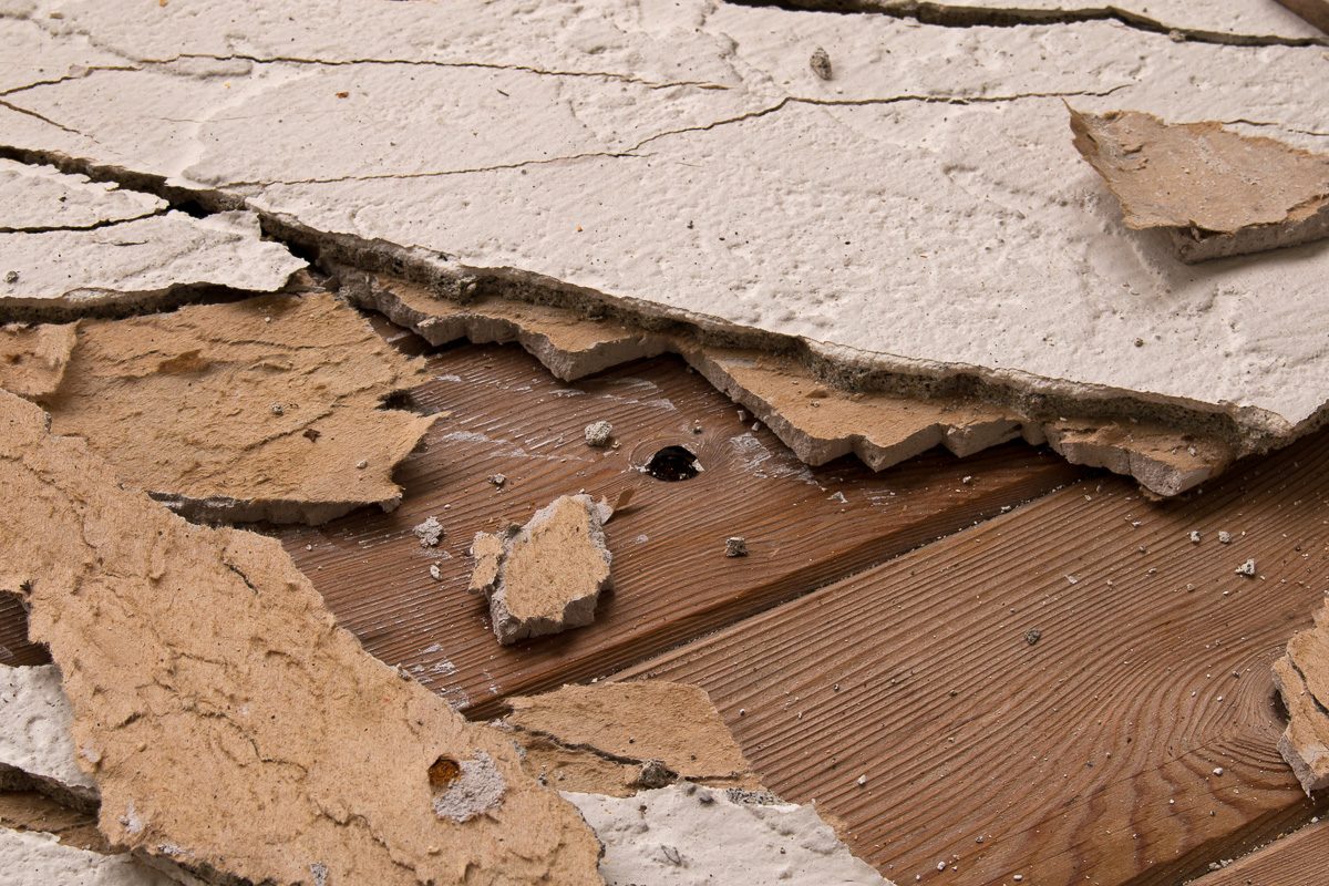Fallen pieces of broken stucco caused by water damage.