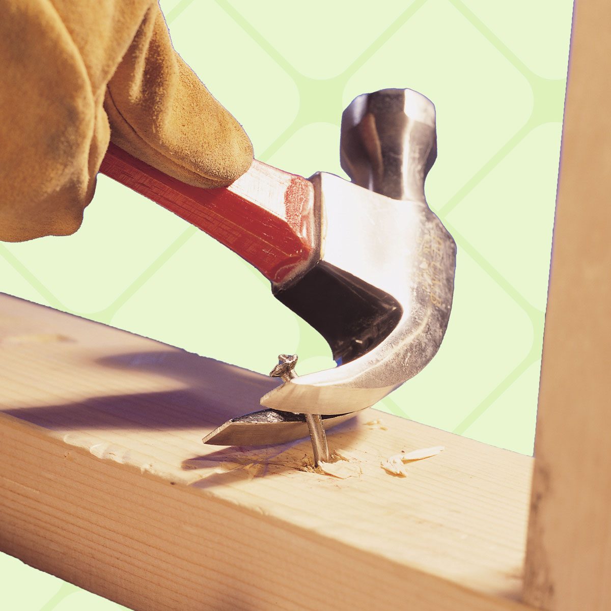 prying nail out with hammer claw