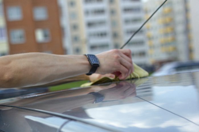 A man fixing car antenna