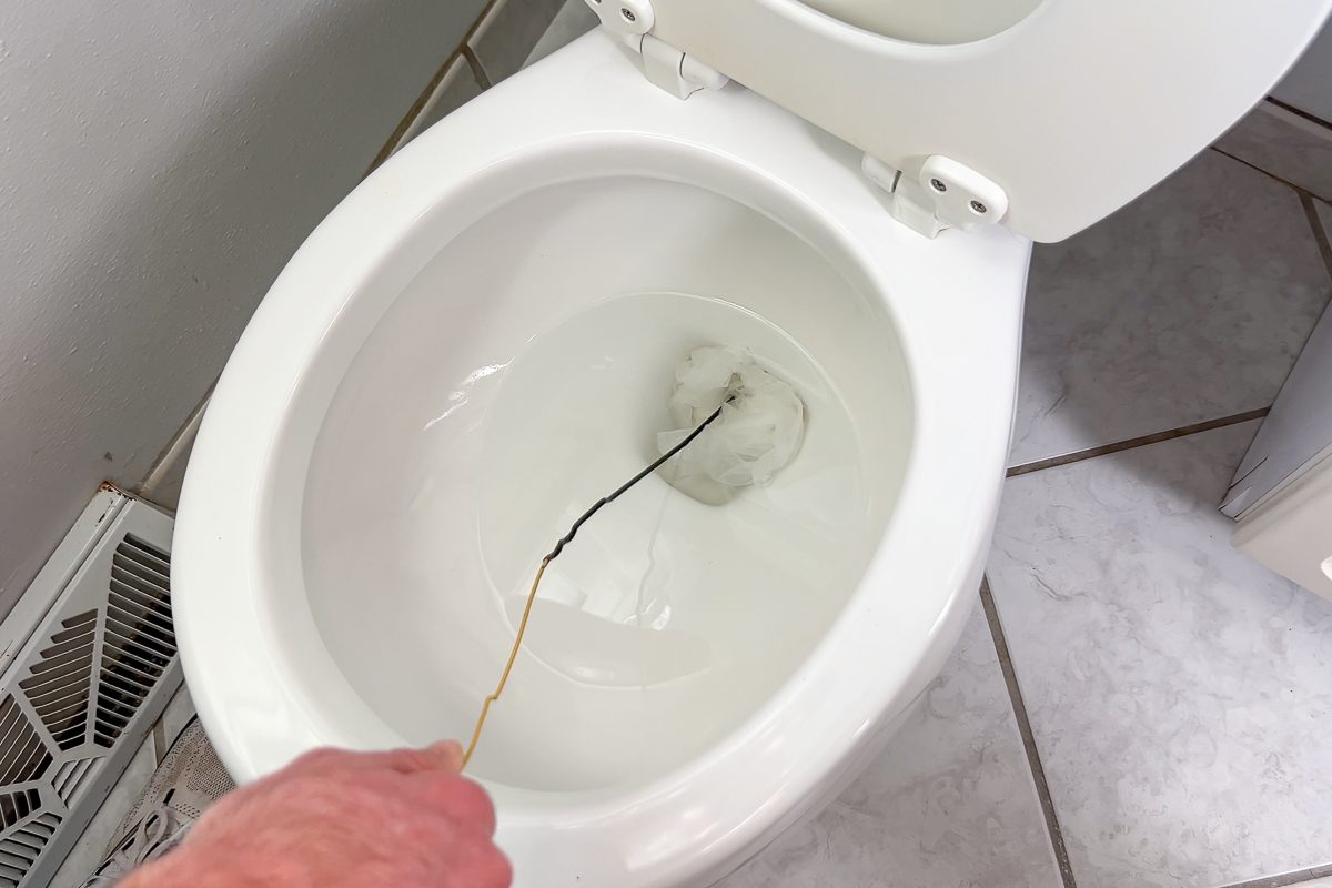 unclogging toilet with wire coat hanger