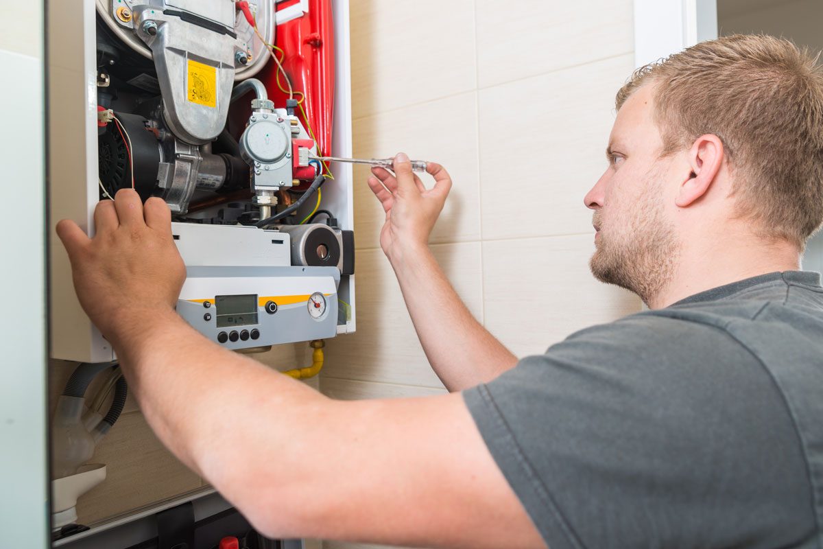 Technician Repairing Gas Furnace Gettyimages 981527878