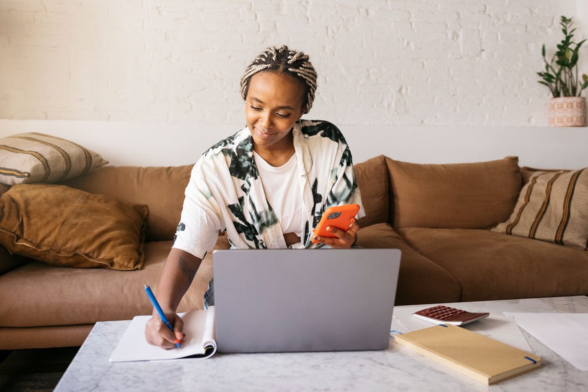 Woman Sitting On A Sofa And Working