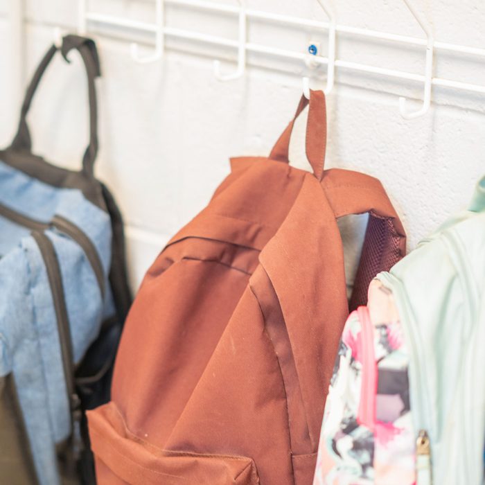 backpacks hanging on hooks