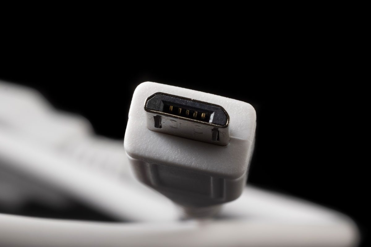 Micro USB type B or USB-B plug and white cable close-up.