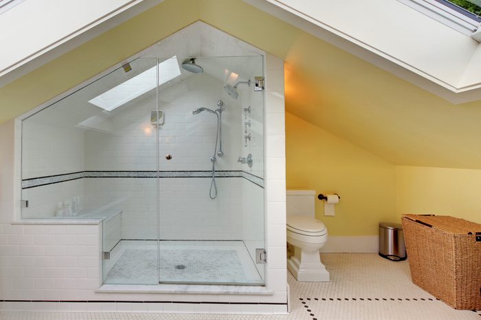 modern bathroom in attic with shower and toilet