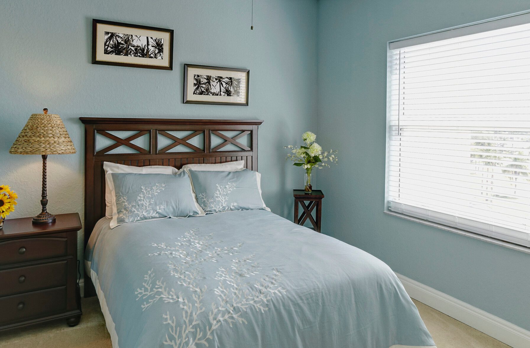 Ceiling fan over bed in bedroom.