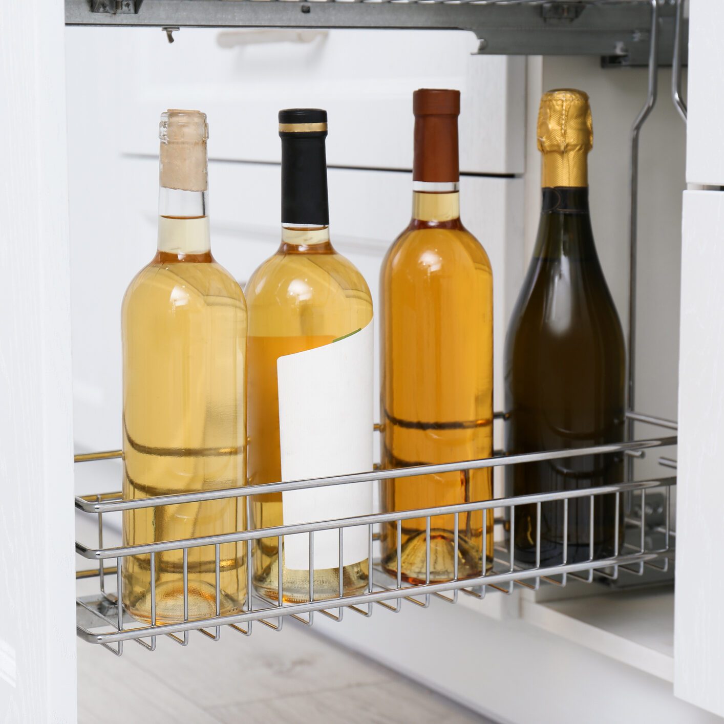 Open drawer with wine bottles in kitchen