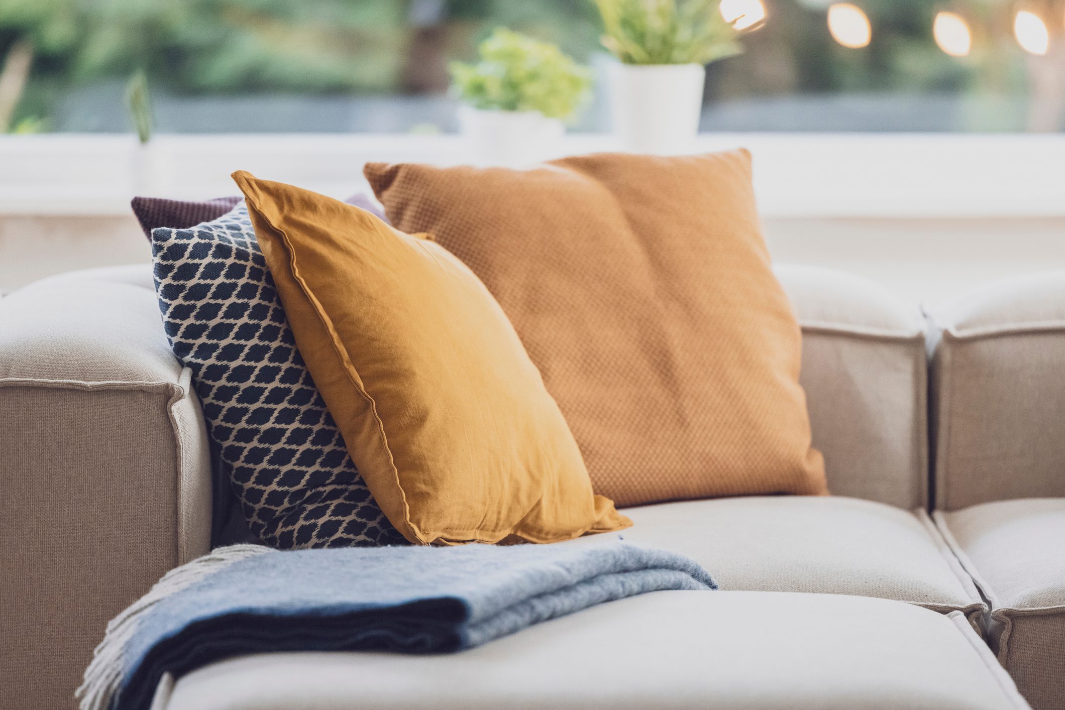 Pillows on a couch in the living room. Decoration Service at a garden party, summer festival, or wedding. Catering.
