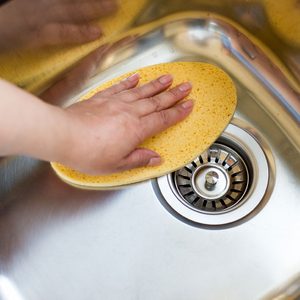 women ploishing the sink