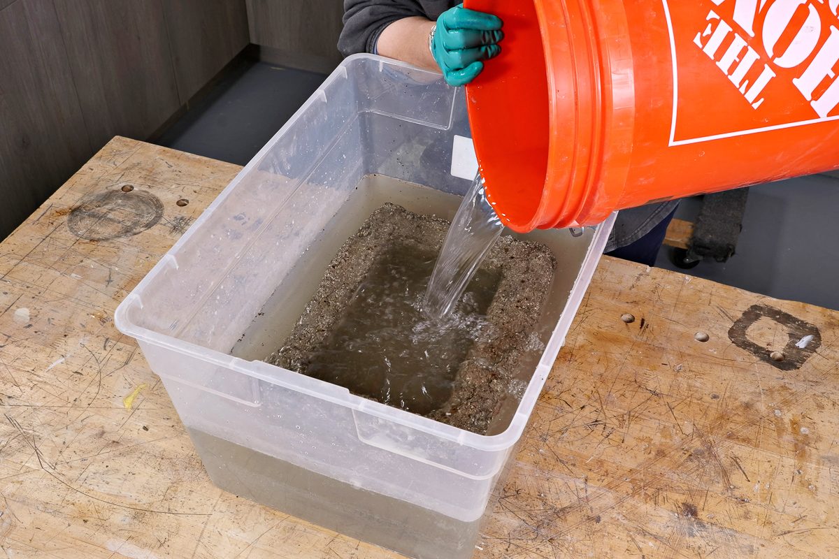 adding water to tub with planter in it