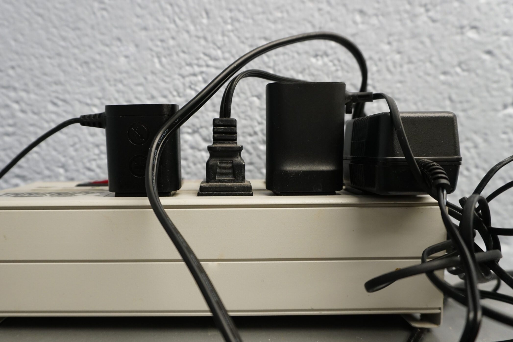 Various power cords plugged into an electric power supply box