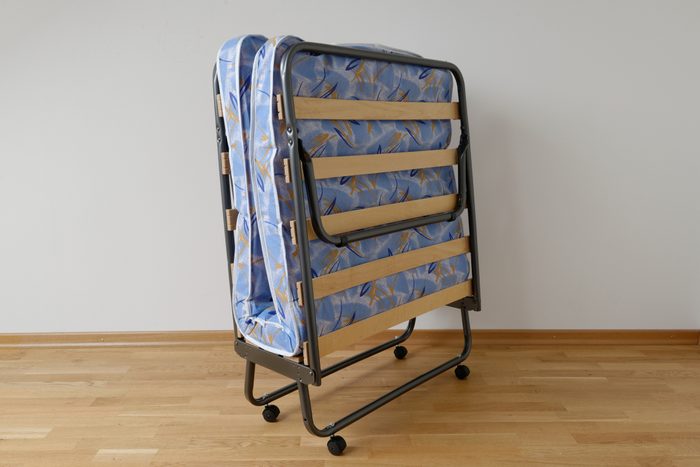 A folding bed in front of a white wall