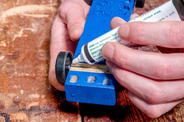 applying graphite lubricant to car wheel